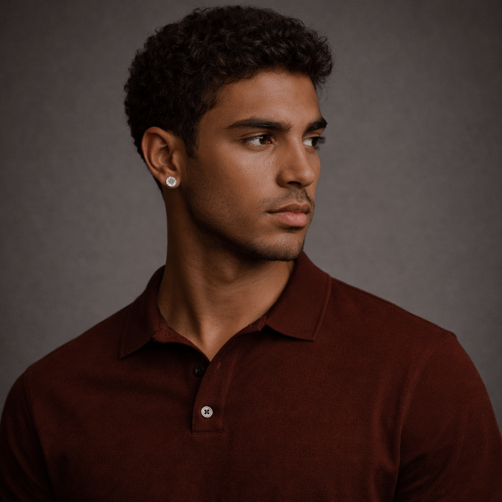 Man wearing a brown polo shirt against a gray background